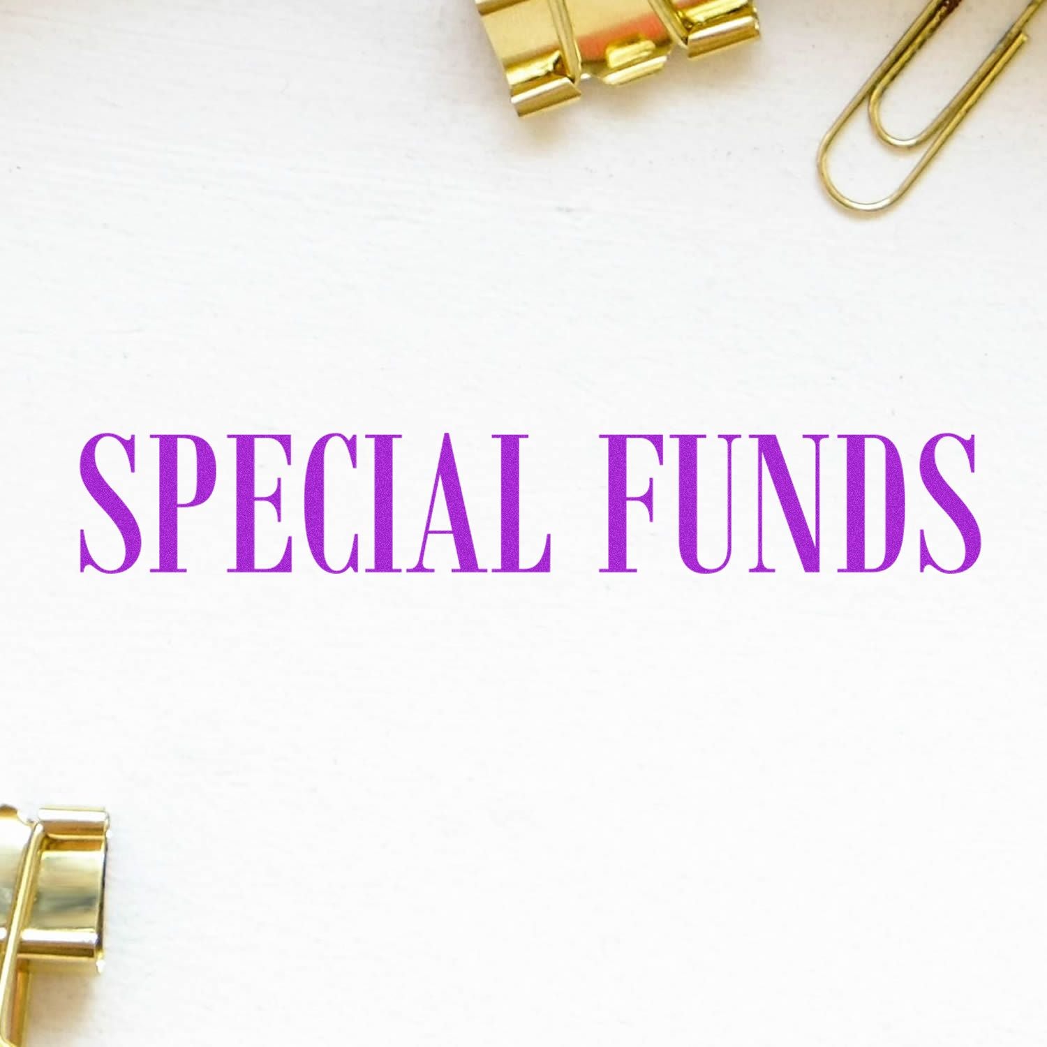 Special Funds Rubber Stamp in purple ink on white paper, surrounded by gold binder clips and paperclips.