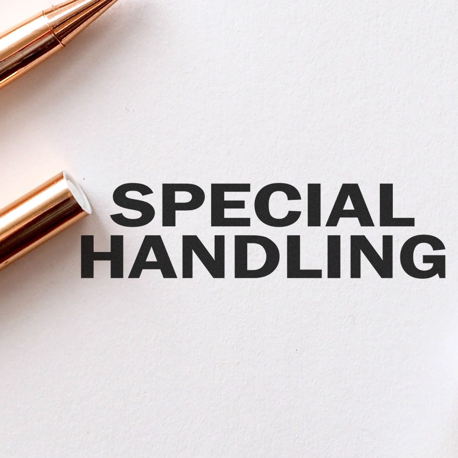 Slim Pre-Inked Special Handling Stamp imprint on white paper with a gold pen nearby.