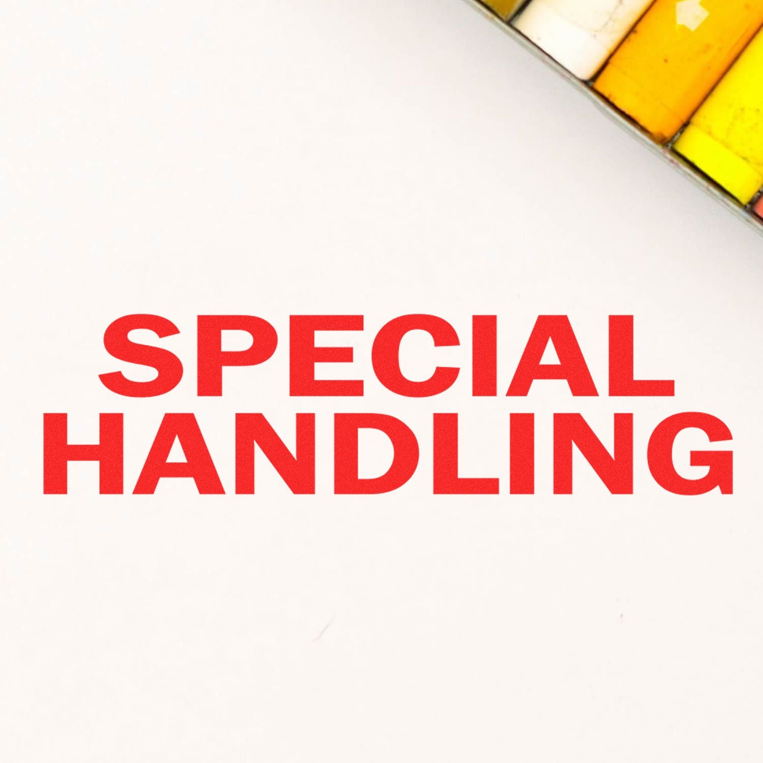 Red 'SPECIAL HANDLING' text stamped on white paper using a Slim Pre-Inked Special Handling Stamp, with colored markers in the corner.