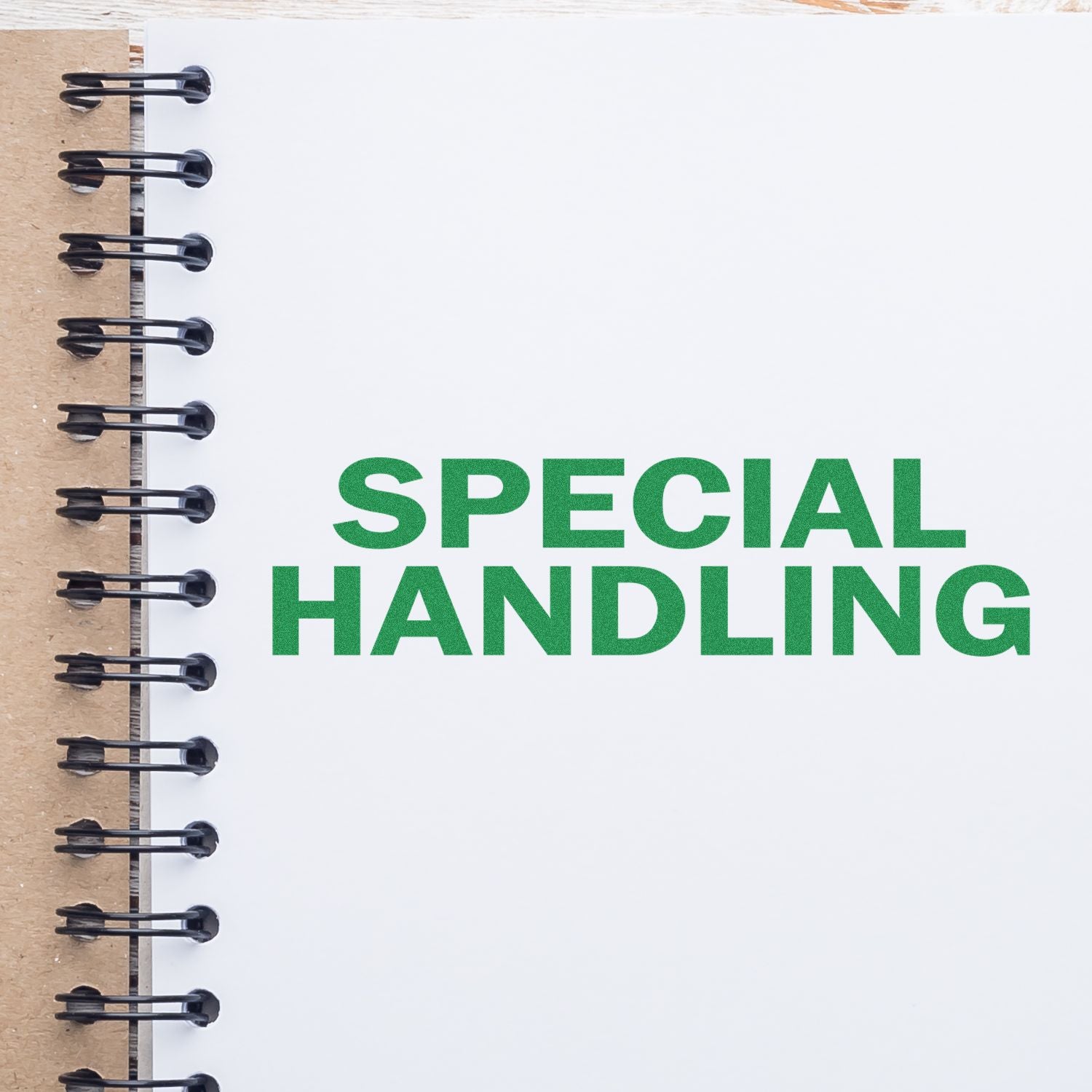 Notebook with 'Special Handling' rubber stamp in green ink on a white page, spiral binding visible on the left.