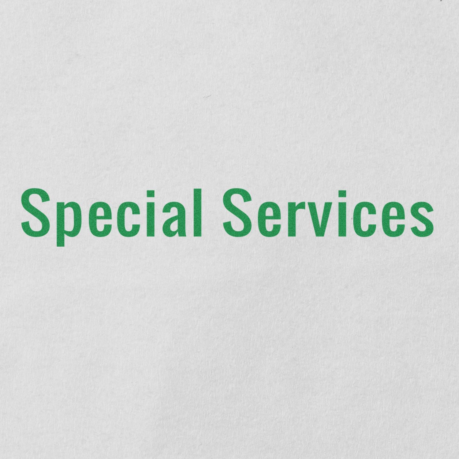 Special Services text stamped in green ink on white paper using a Slim Pre-Inked Special Services Stamp.