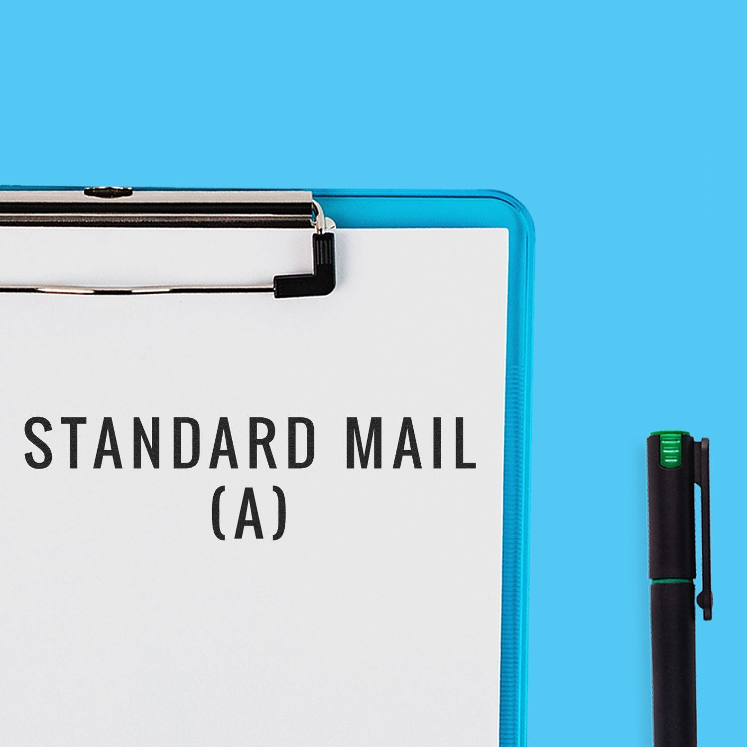 Clipboard with Standard Mail (A) rubber stamp impression on paper, next to a black pen on a blue background.