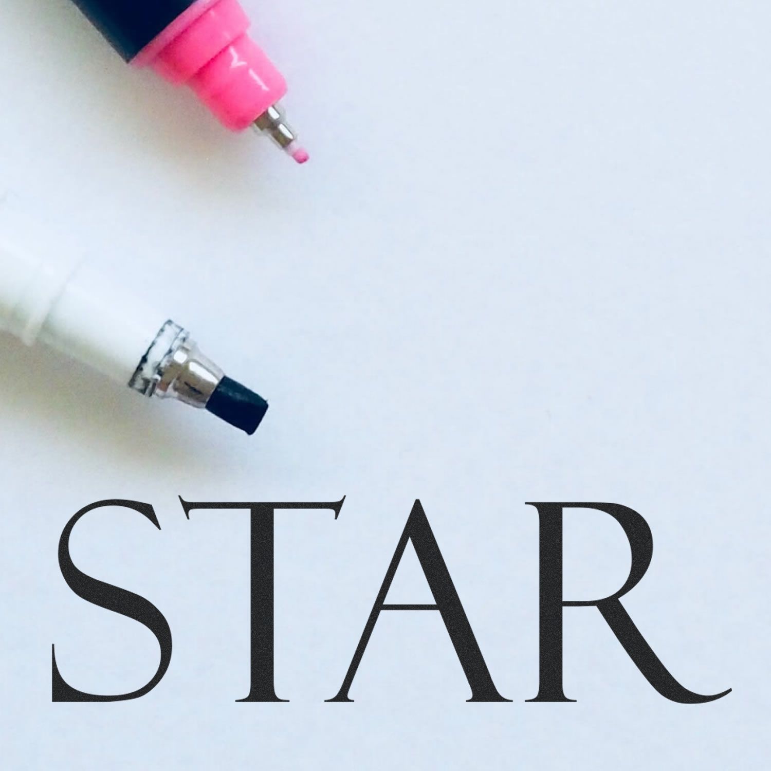 Two markers, one pink and one black, with the text "STAR" below them. The image showcases the Star Rubber Stamp product.