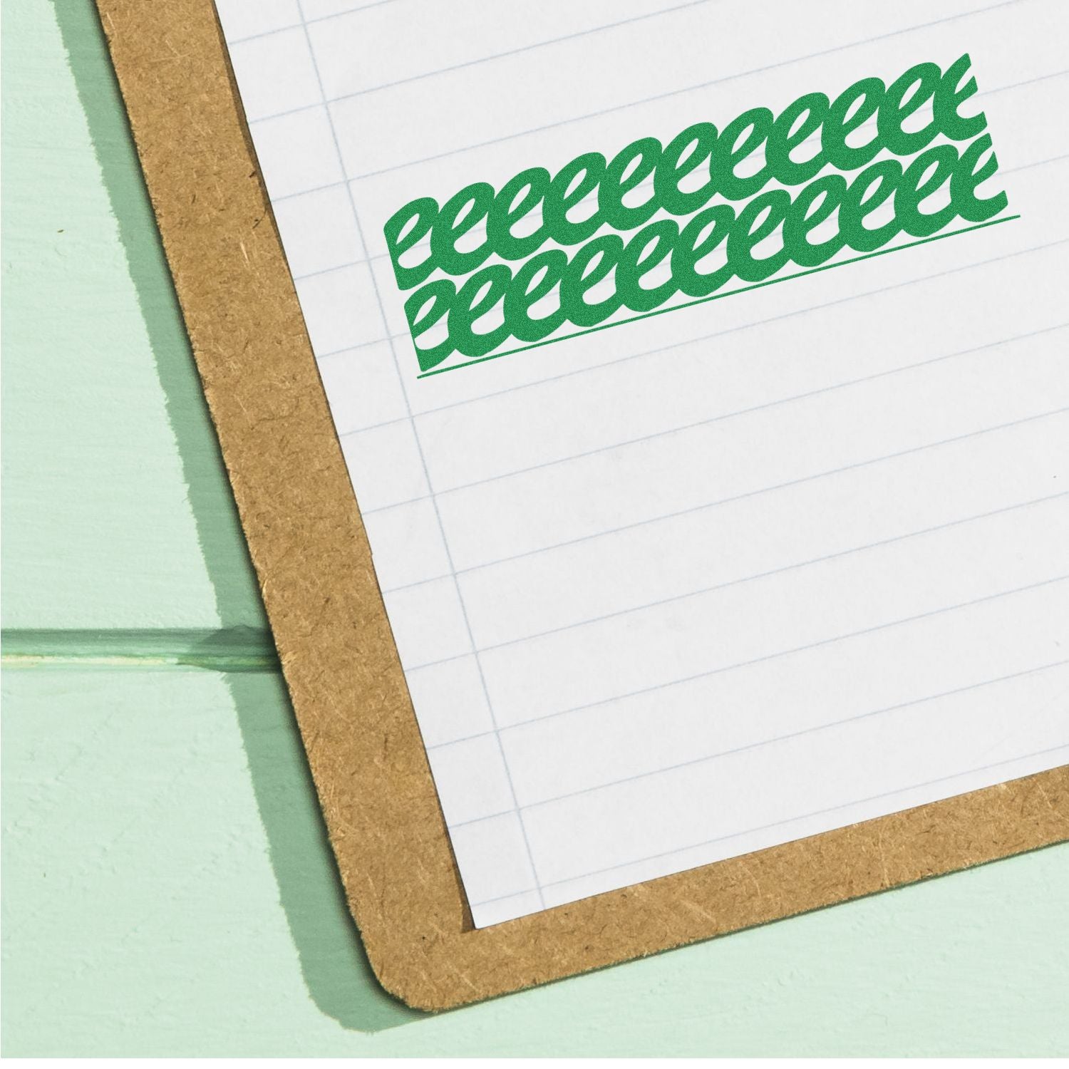 Strikeout Rubber Stamp in green ink used repeatedly on lined paper attached to a brown clipboard on a green surface.