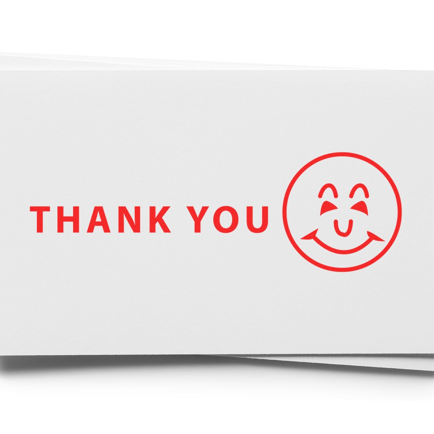 Thank You with Smiley Rubber Stamp in red ink on white paper, featuring a smiling face next to the words Thank You.