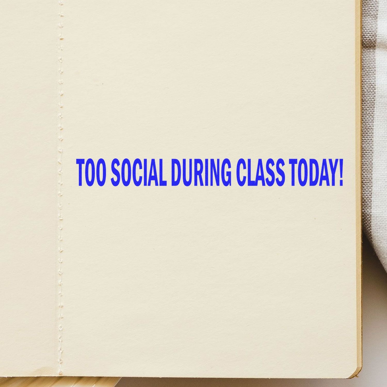 Large Self-Inking Too Social During Class Today Stamp used on a notebook, displaying the text TOO SOCIAL DURING CLASS TODAY! in blue ink.