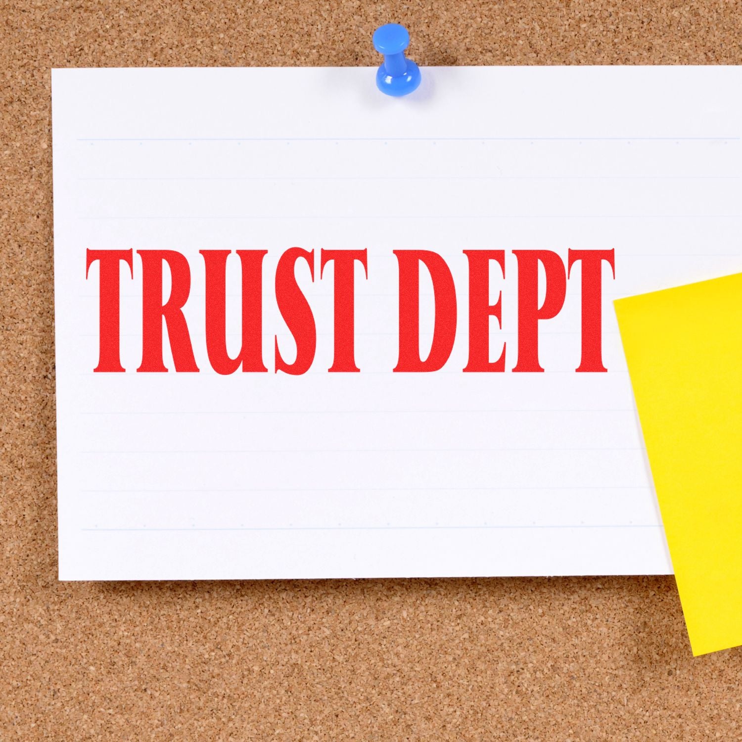 A corkboard with a pinned note stamped TRUST DEPT in red ink using the Large Self Inking Trust Dept Stamp, next to a yellow sticky note.