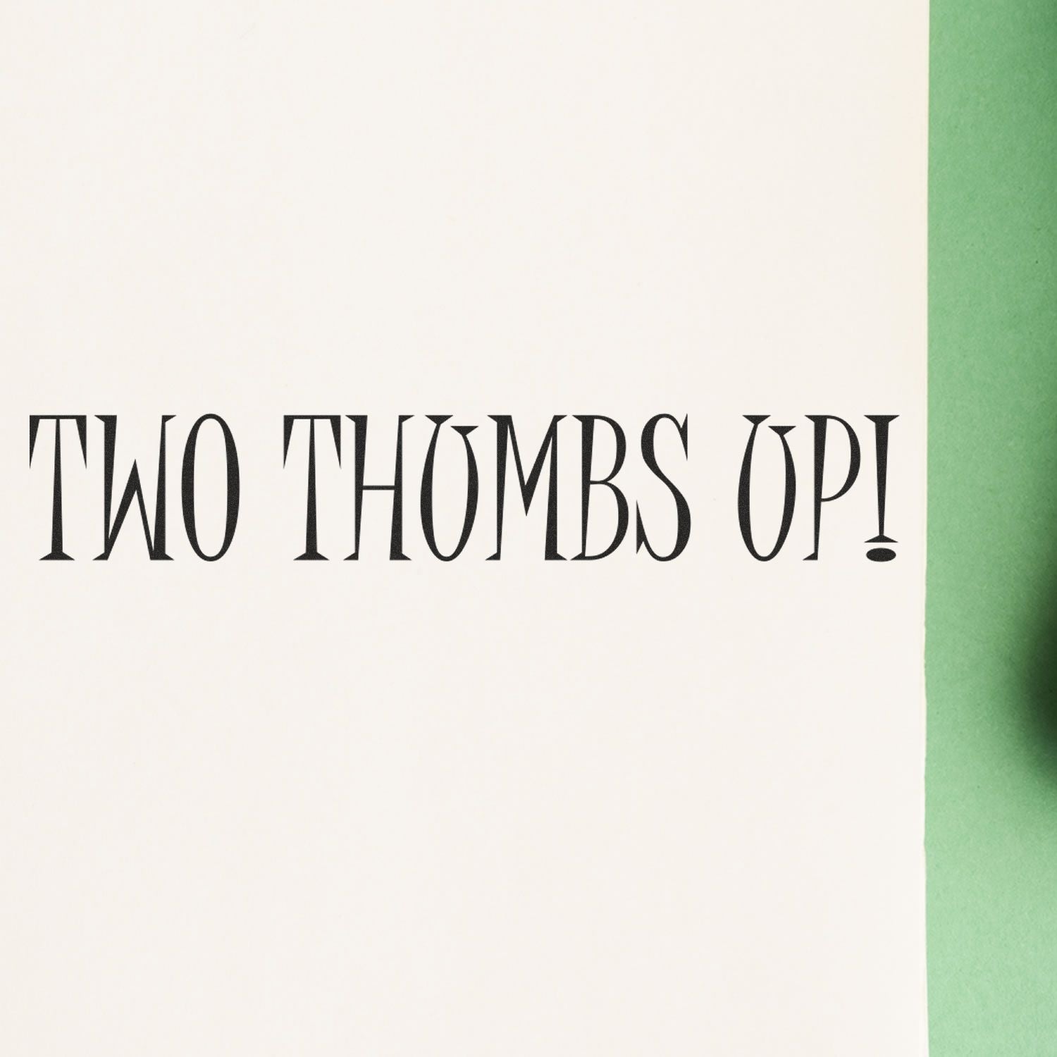 Two Thumbs Up Rubber Stamp impression on white paper with green background, showing the text 'TWO THUMBS UP!'