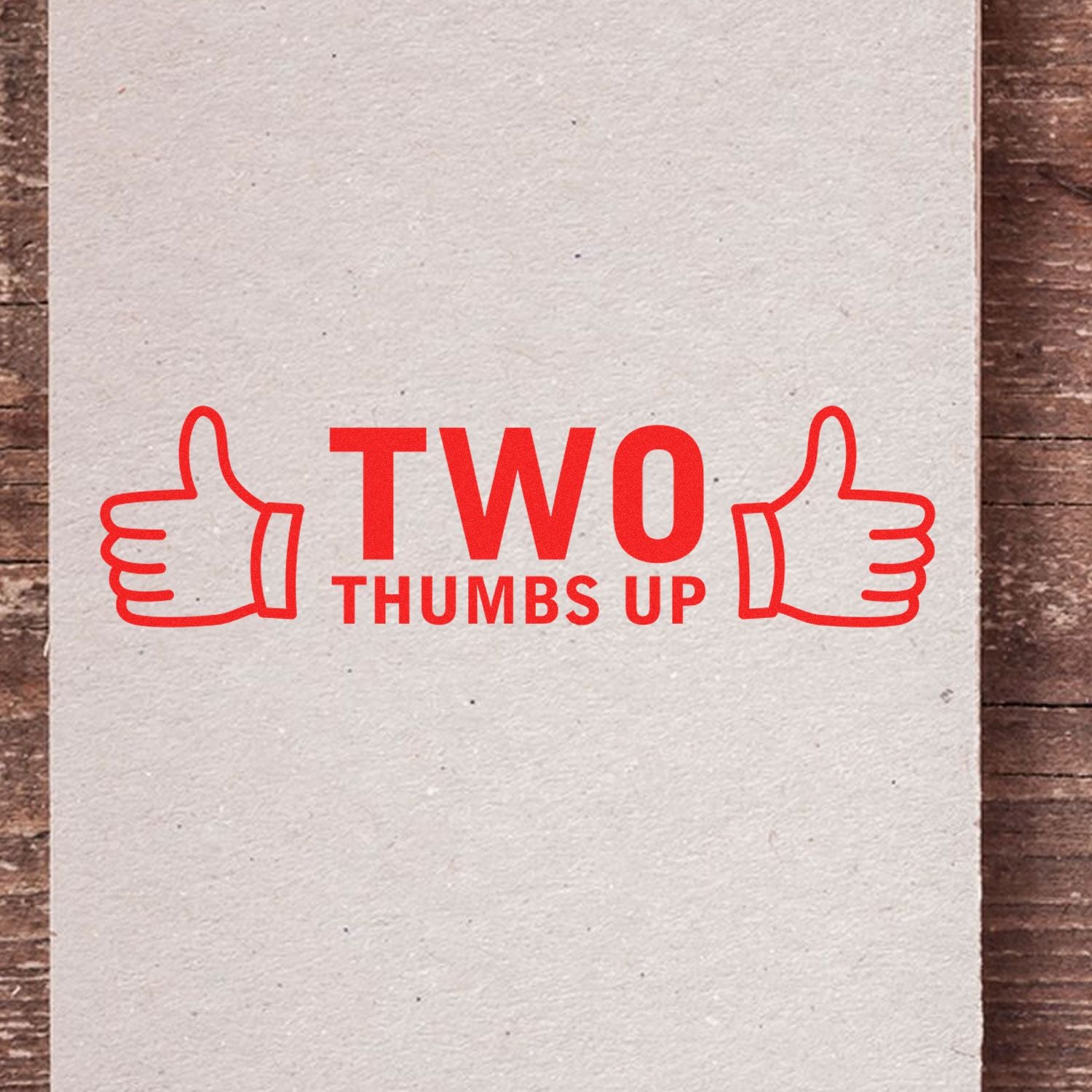 Slim Pre-Inked Two Thumbs Up with Thumb Icon Stamp in red ink on a beige paper, featuring two thumbs up icons.