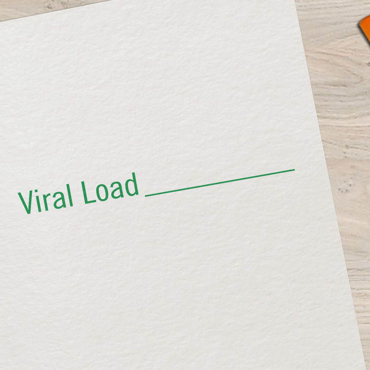 Close-up of a white paper stamped with 'Viral Load' in green ink, with a blank line for additional information.