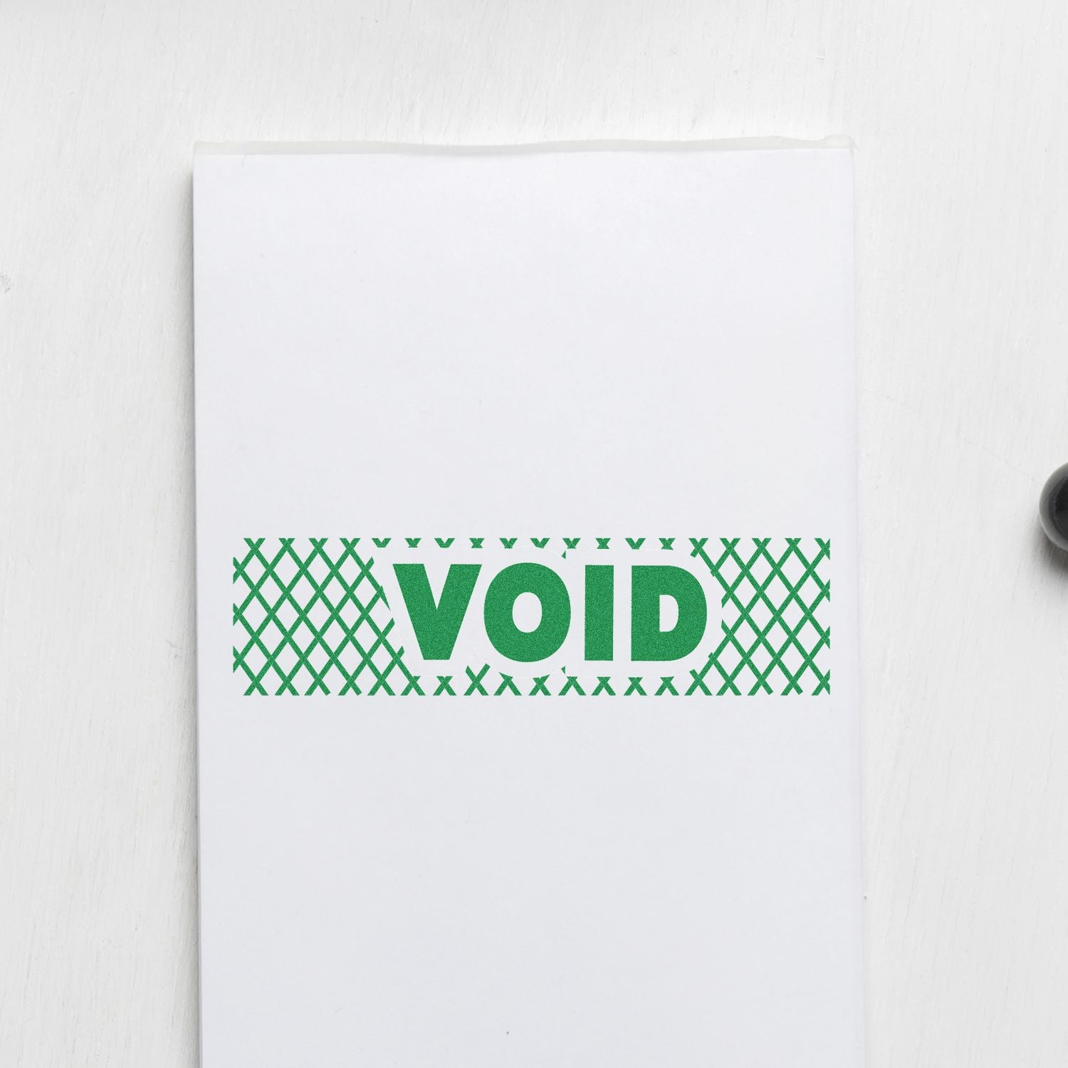 Self Inking Void with Strikelines Stamp in green ink on white paper, showing the word VOID with a crosshatch pattern background.