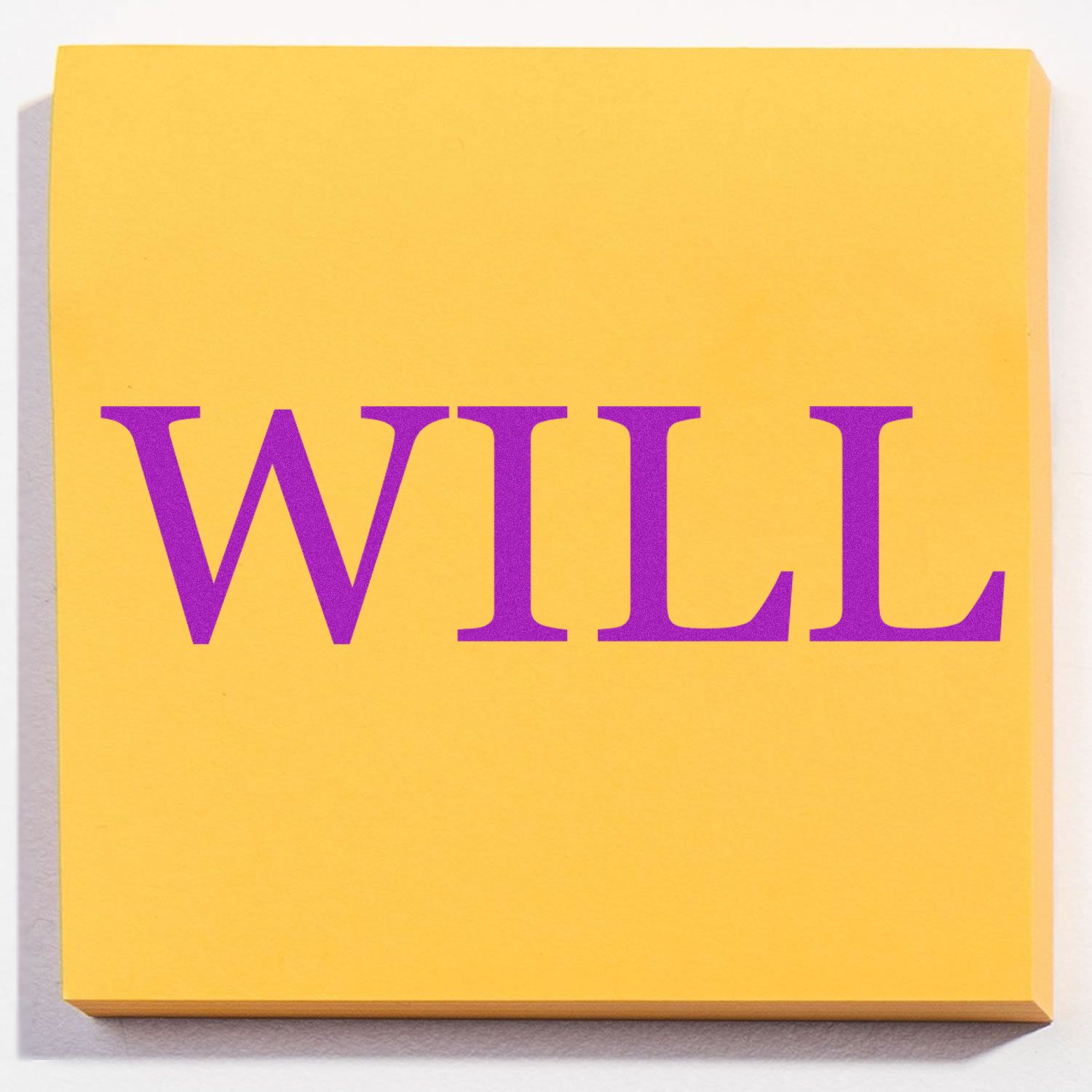 Yellow sticky note with the word WILL stamped in purple using a Slim Pre-Inked Will Stamp.