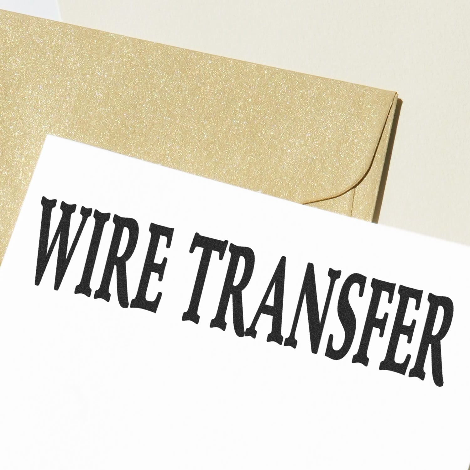 Wire Transfer rubber stamp impression on white paper with a golden envelope in the background.