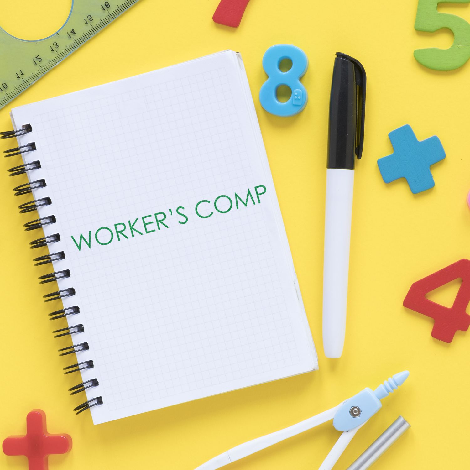 Notebook with WORKER'S COMP text, surrounded by a pen, ruler, compass, and colorful numbers on a yellow background.