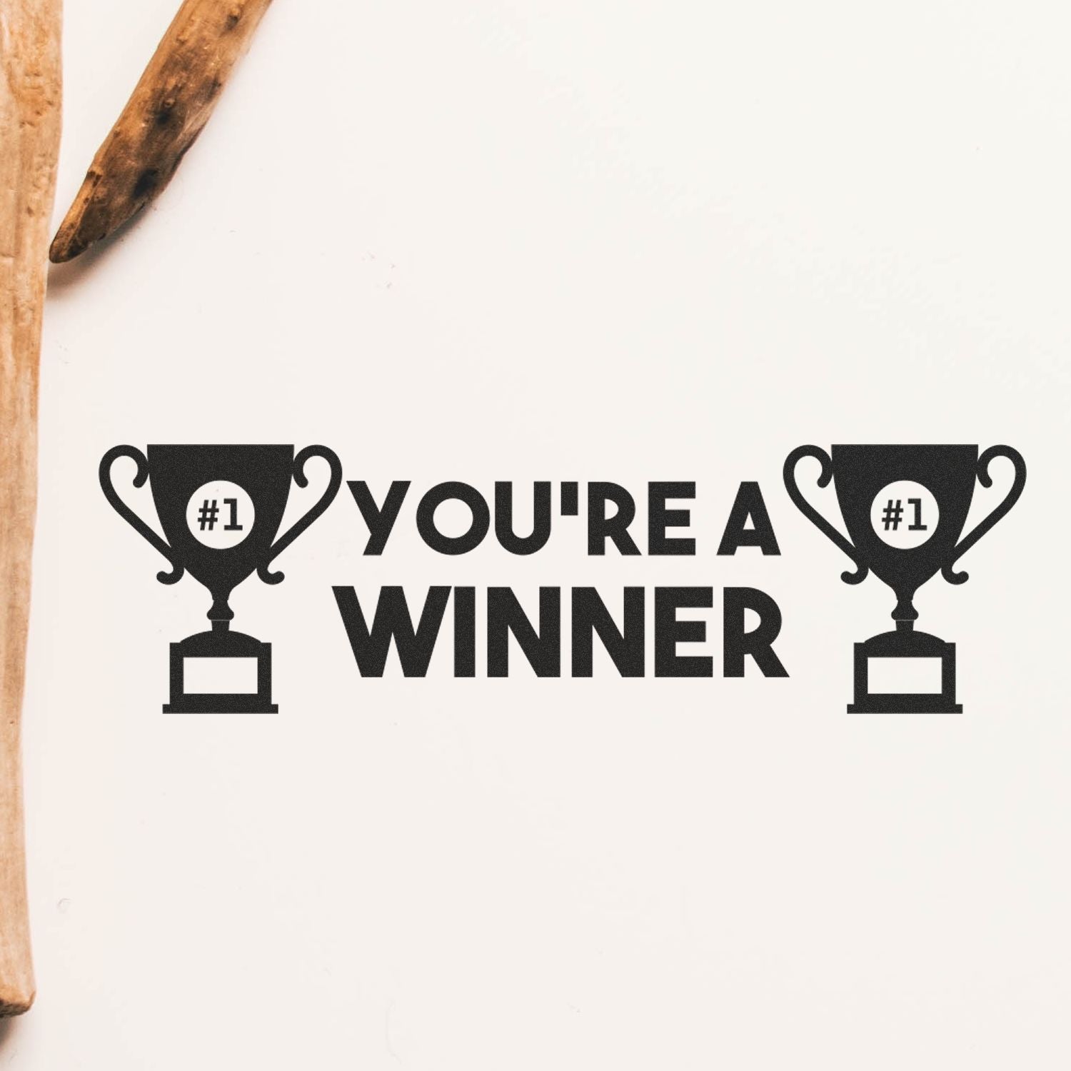 You're a Winner Rubber Stamp with two trophy icons and the text 'You're a Winner' stamped in black on a white surface.