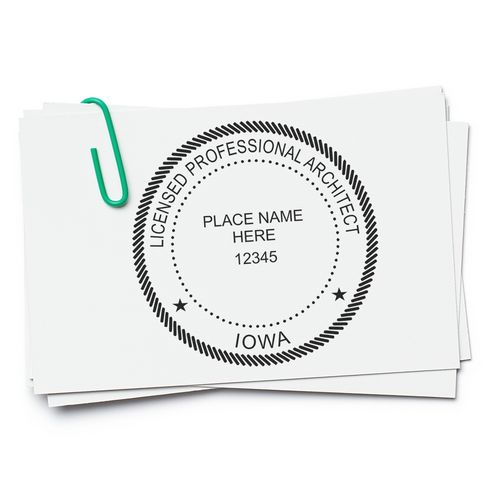 Iowa Architect Seal Stamp on white paper with a green paperclip, displaying 'Licensed Professional Architect, Iowa' and space for name and number.