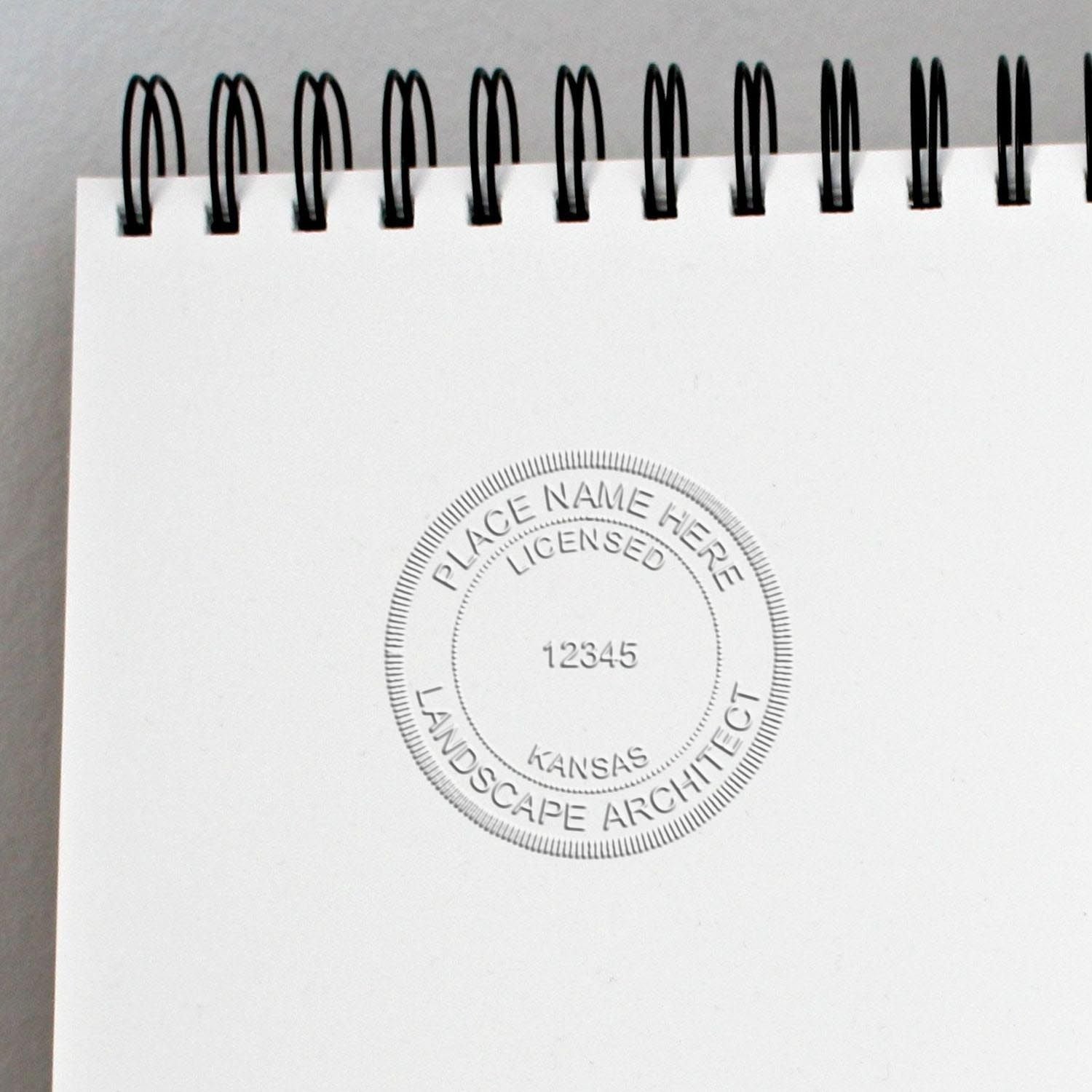 The State of Kansas Handheld Landscape Architect Seal stamp impression comes to life with a crisp, detailed photo on paper - showcasing true professional quality.