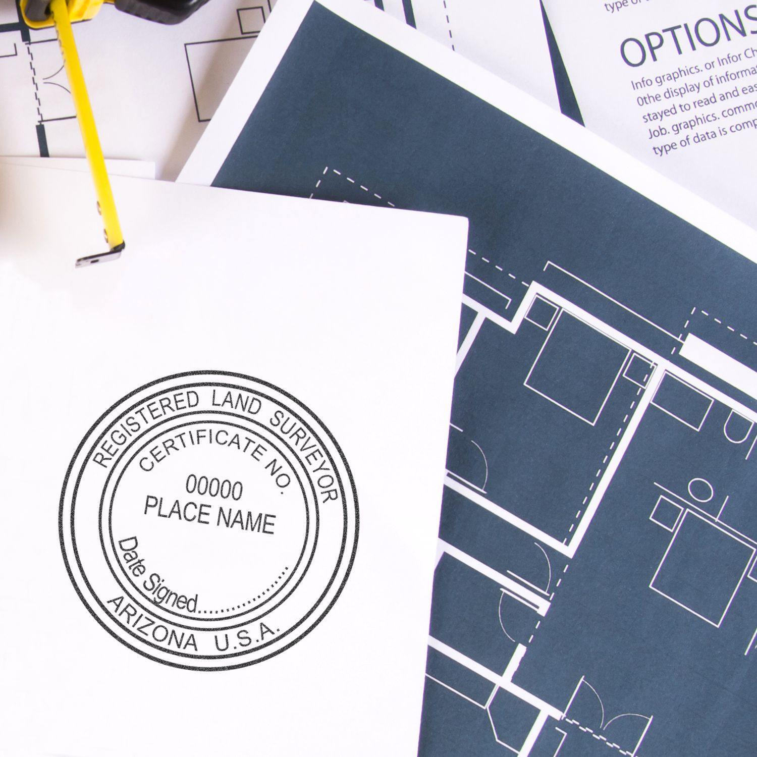 Land Surveyor eSeal Electronic Image Stamp of Seal on a white document, next to blueprints and a binder clip.