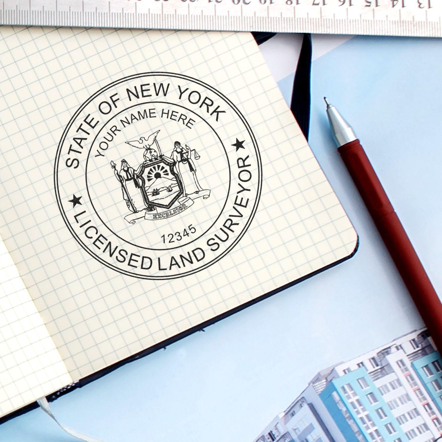 Land Surveyor eSeal Electronic Image Stamp of Seal on a notebook, with a ruler and pen nearby, featuring the State of New York licensed land surveyor seal.