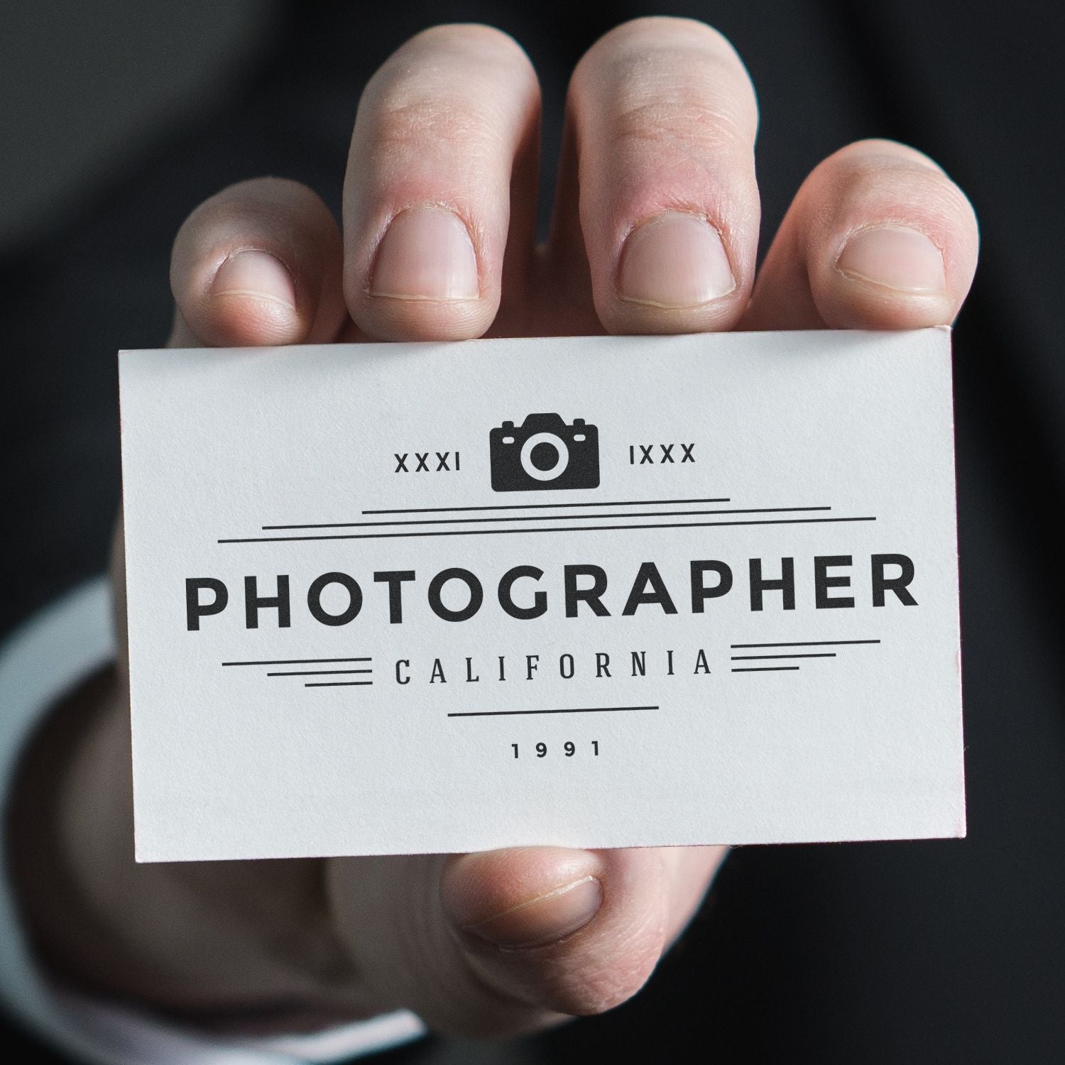 Hand holding a business card stamped with PHOTOGRAPHER CALIFORNIA using a Custom Rubber Stamp Size 2 x 3.