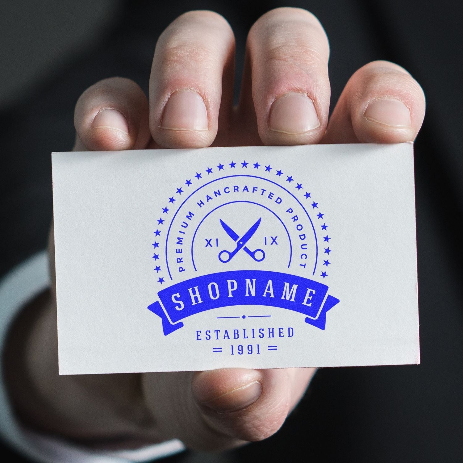 Hand holding a business card stamped with Custom Self-Inking Stamp Trodat 52045 (Size: 1-3/4 Diameter), displaying a blue logo and text.