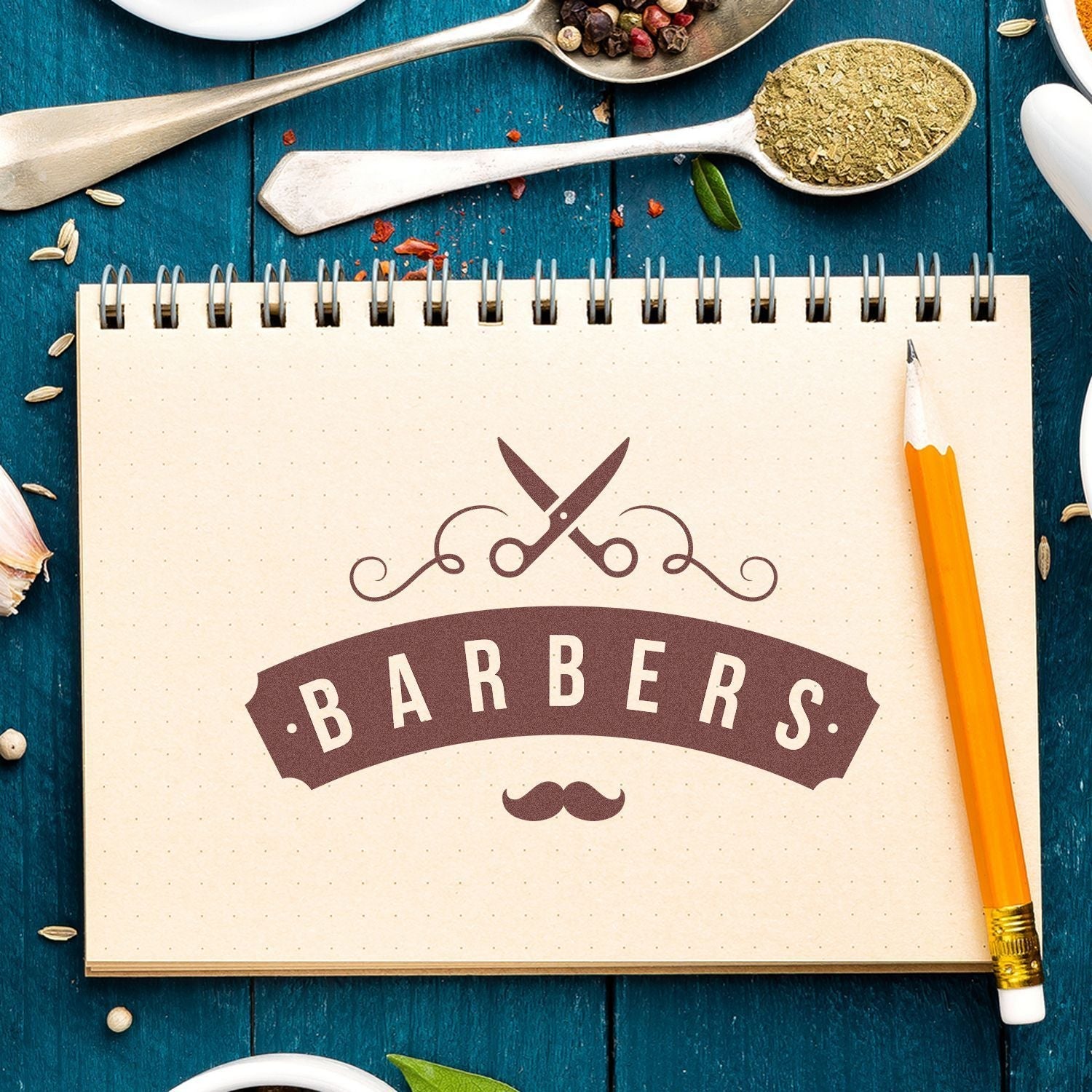 A Custom Rubber Stamp Size 4 x 10 imprinting Barbers with scissors and mustache design on a notebook, surrounded by spices and a pencil.