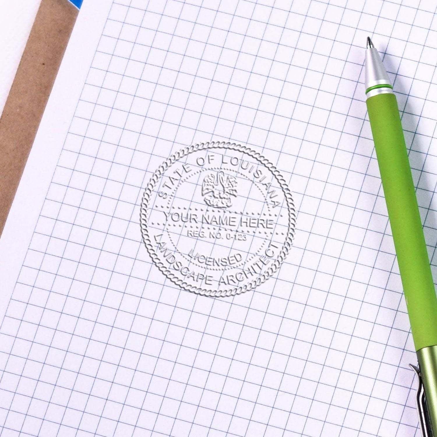 An in use photo of the Gift Louisiana Landscape Architect Seal showing a sample imprint on a cardstock