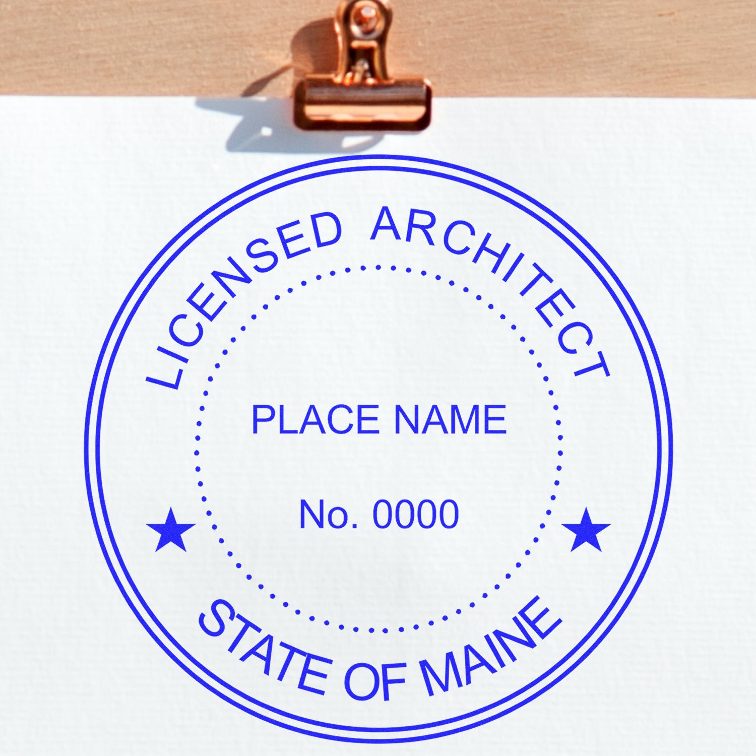 Image of a Maine Architect Seal Stamp with text Licensed Architect, State of Maine, Place Name, No. 0000 in blue on a white background.