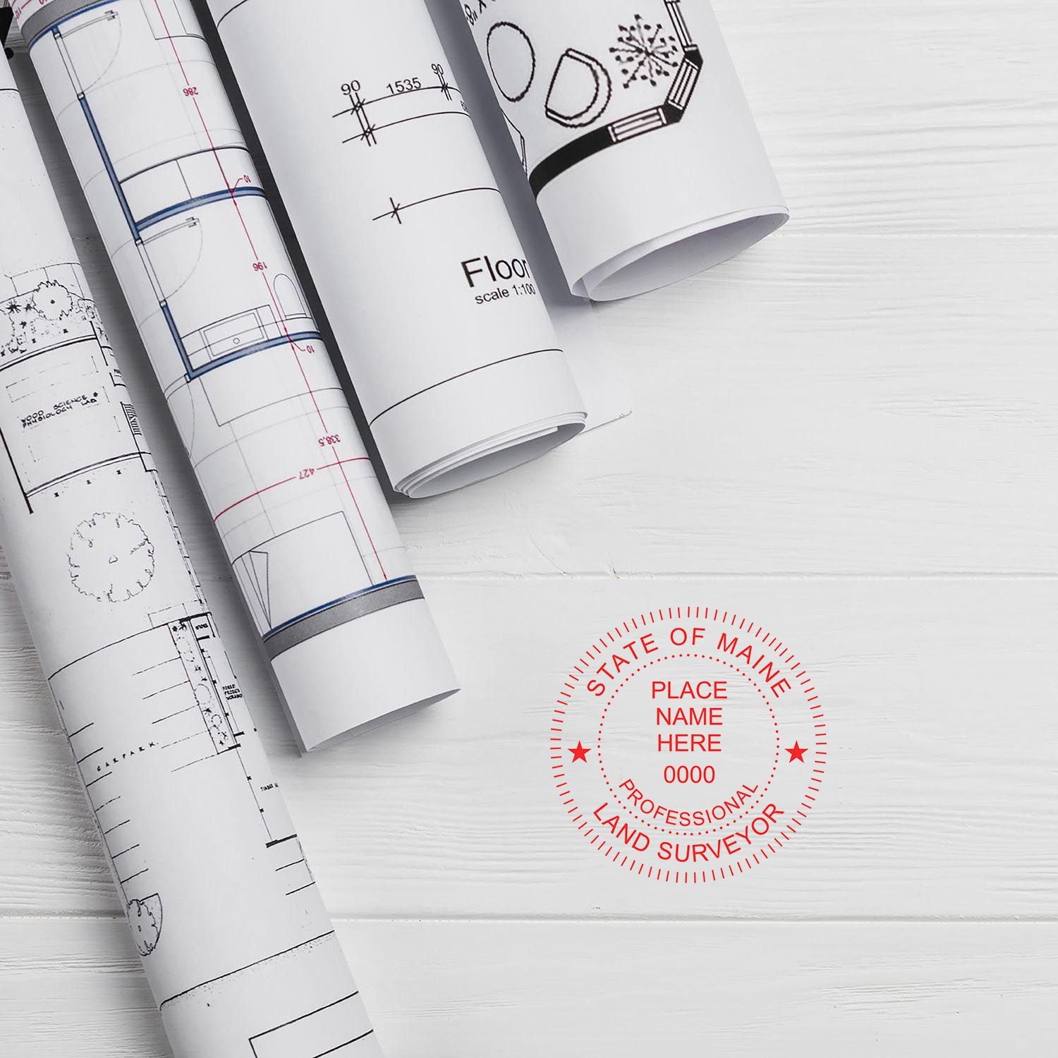 Rolled blueprints on a white surface with a red Digital Maine Land Surveyor Stamp, Electronic Seal for Maine Land Surveyor.