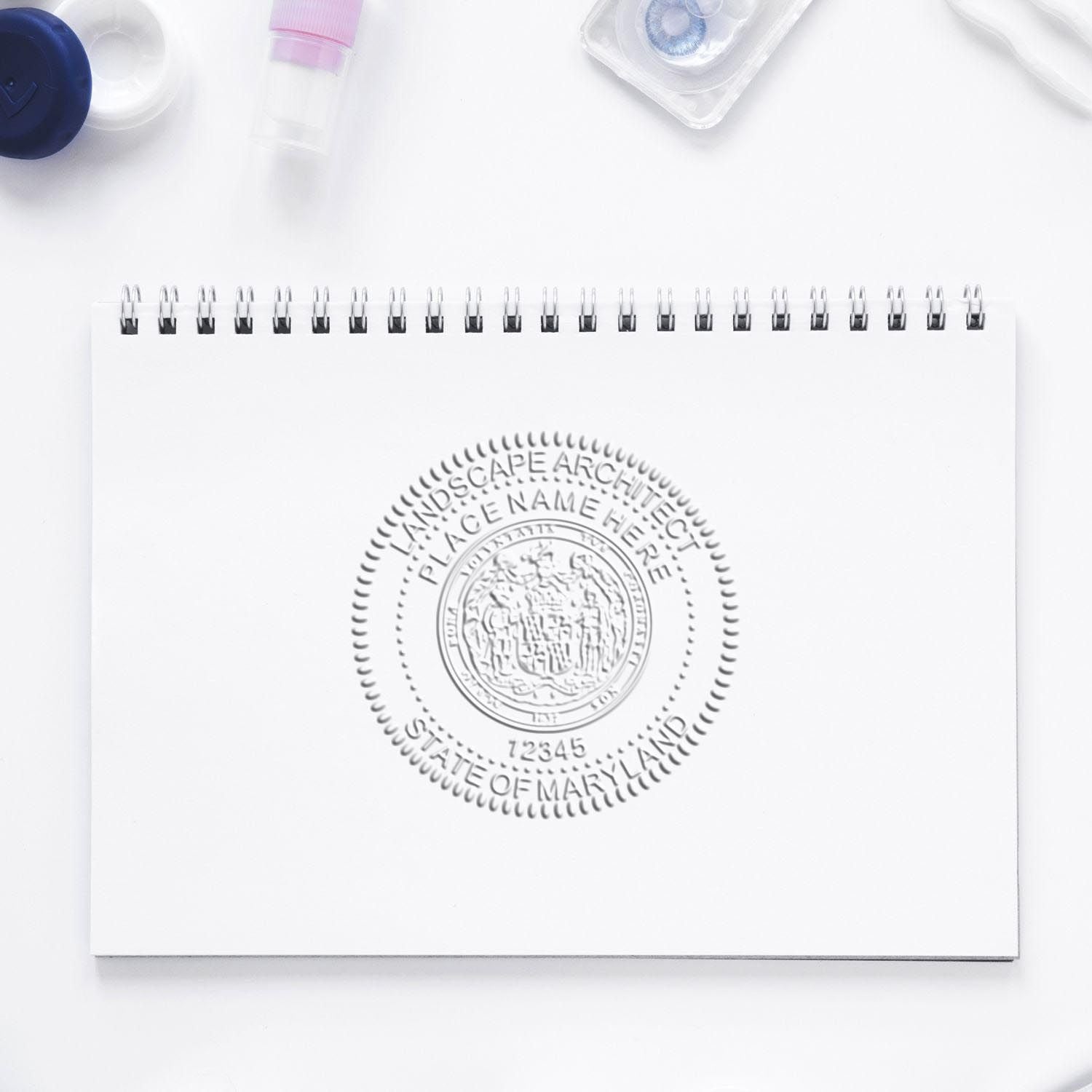 The State of Maryland Handheld Landscape Architect Seal stamp impression comes to life with a crisp, detailed photo on paper - showcasing true professional quality.