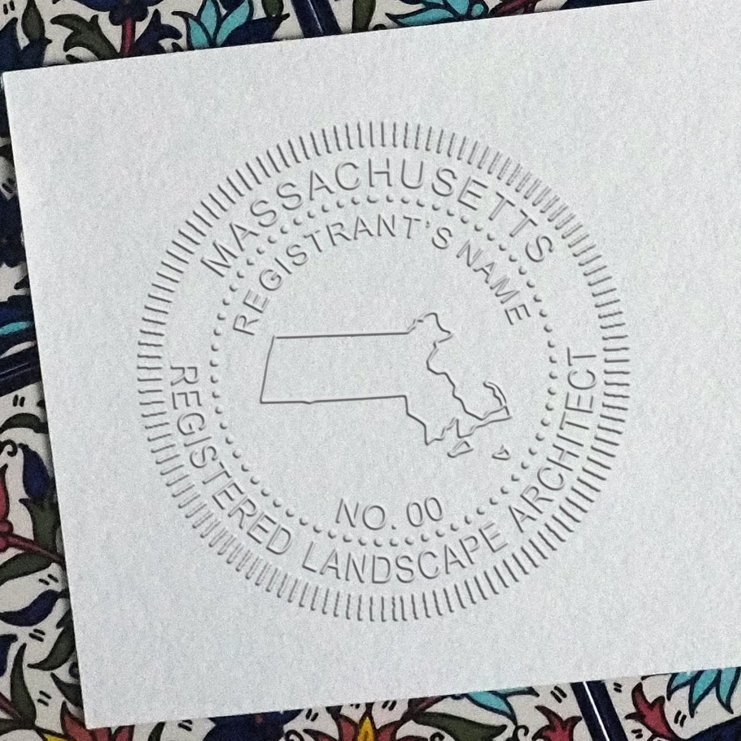 A photograph of the State of Massachusetts Handheld Landscape Architect Seal stamp impression reveals a vivid, professional image of the on paper.