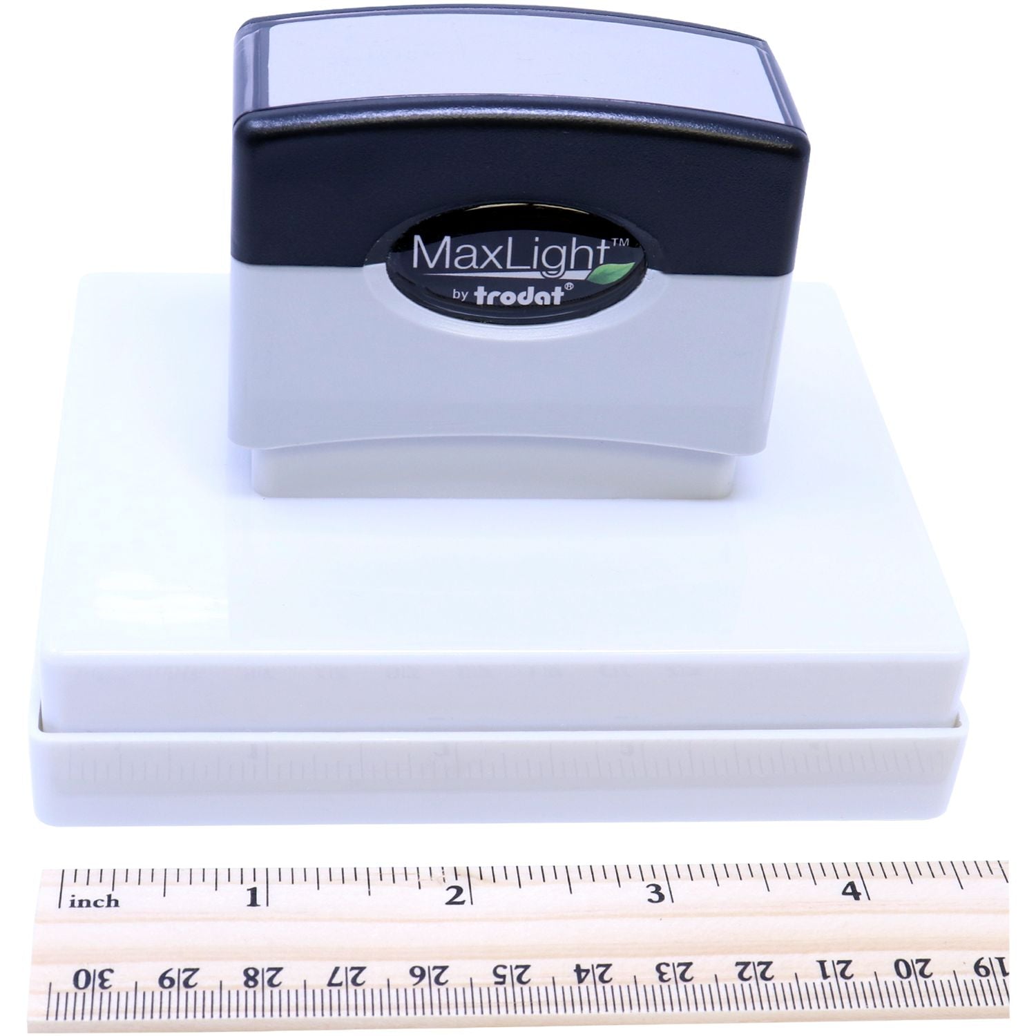 MaxLight XL2-700 Custom Pre-Inked Business Stamp 2-3/4-x 3-3/4 shown with a ruler for scale, highlighting its compact design.