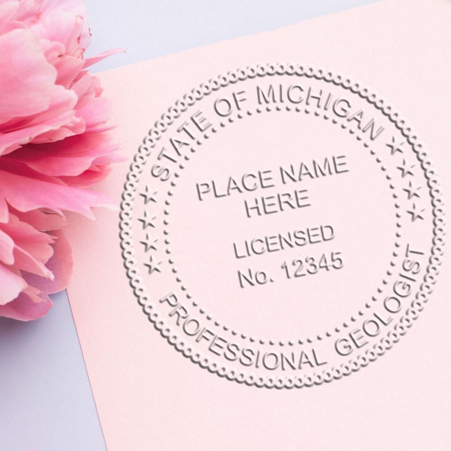 An in use photo of the Michigan Geologist Desk Seal showing a sample imprint on a cardstock