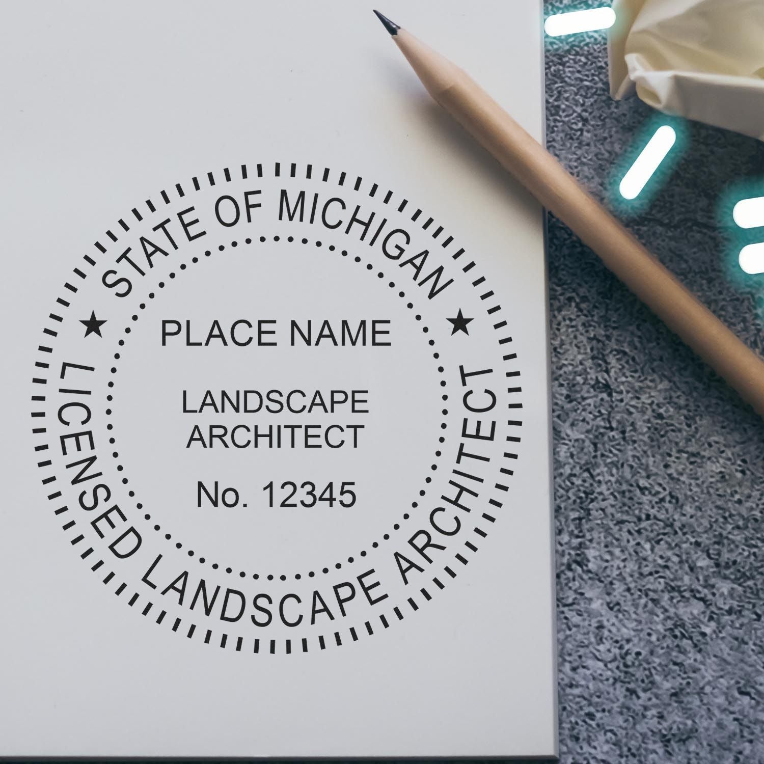 A lifestyle photo showing a stamped image of the Michigan Landscape Architectural Seal Stamp on a piece of paper