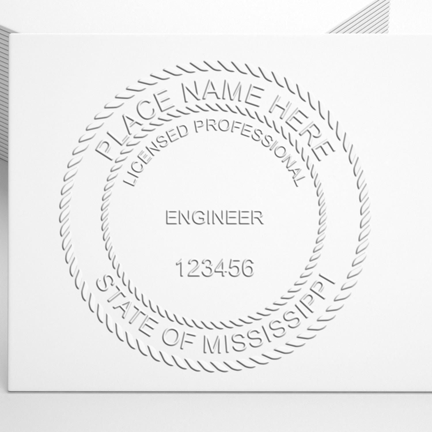 An in use photo of the Hybrid Mississippi Engineer Seal showing a sample imprint on a cardstock