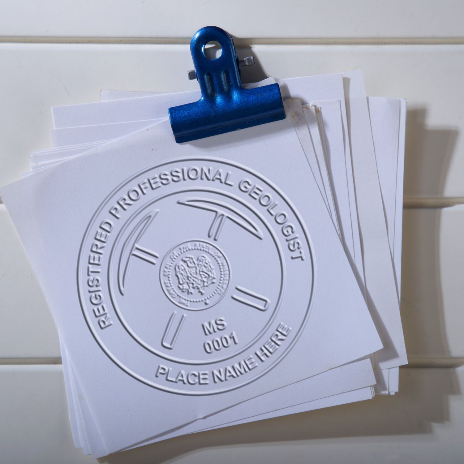 An in use photo of the Hybrid Mississippi Geologist Seal showing a sample imprint on a cardstock