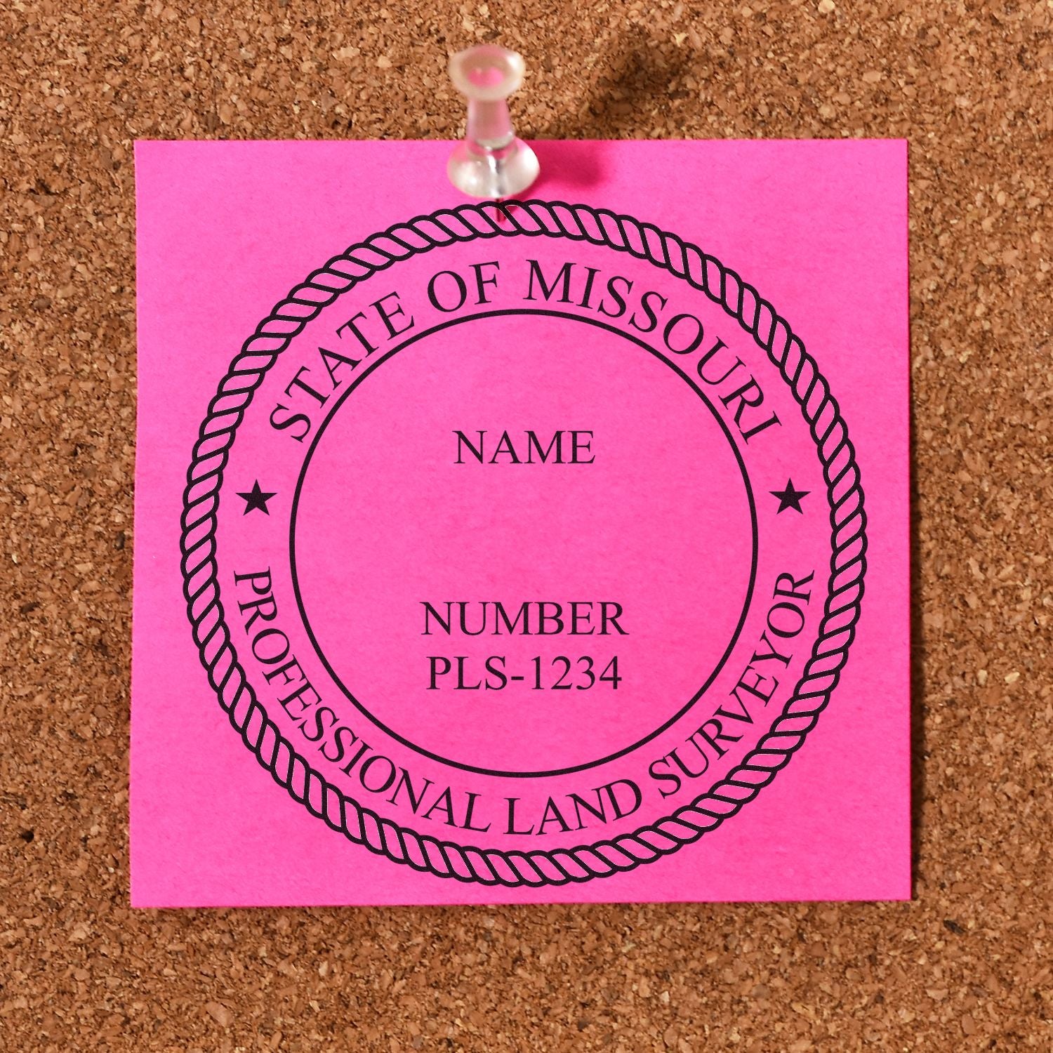 Premium MaxLight Pre-Inked Missouri Surveyors Stamp imprint on a pink sticky note pinned to a corkboard.