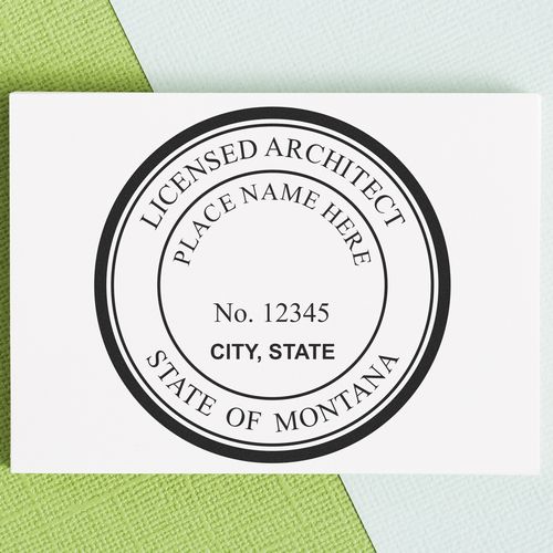 Self Inking Montana Architect Stamp on a textured green and blue background, displaying a customizable licensed architect seal for Montana.