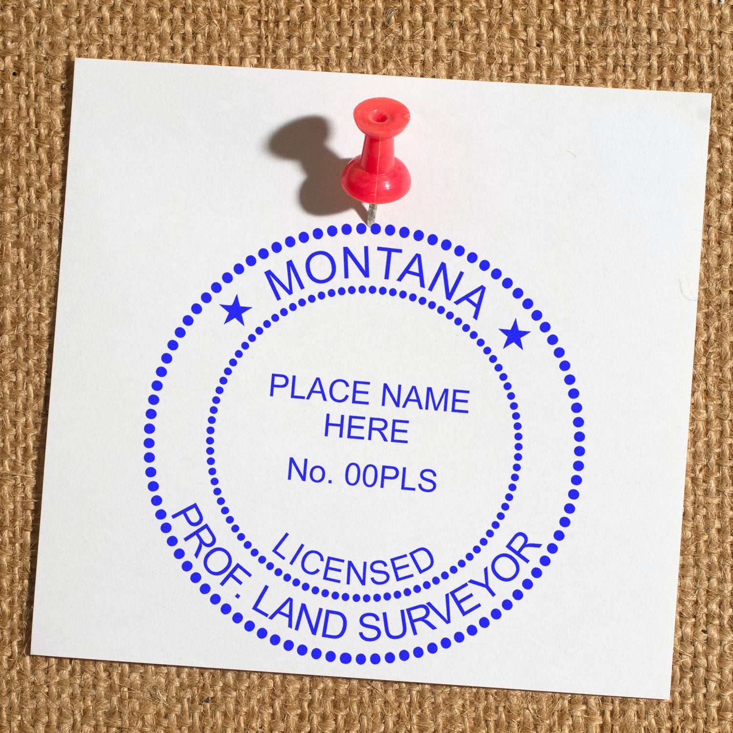 Premium MaxLight Pre-Inked Montana Surveyors Stamp on white paper with a red push pin, displaying customizable licensed land surveyor details.