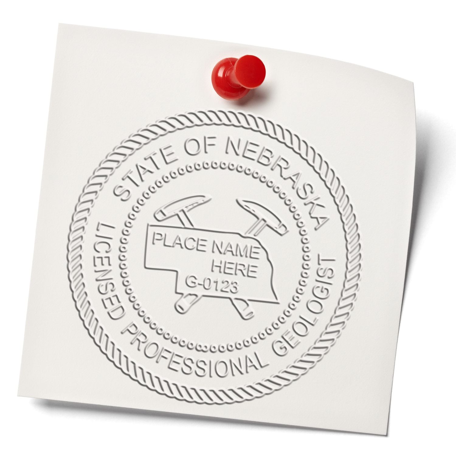 An in use photo of the Nebraska Geologist Desk Seal showing a sample imprint on a cardstock