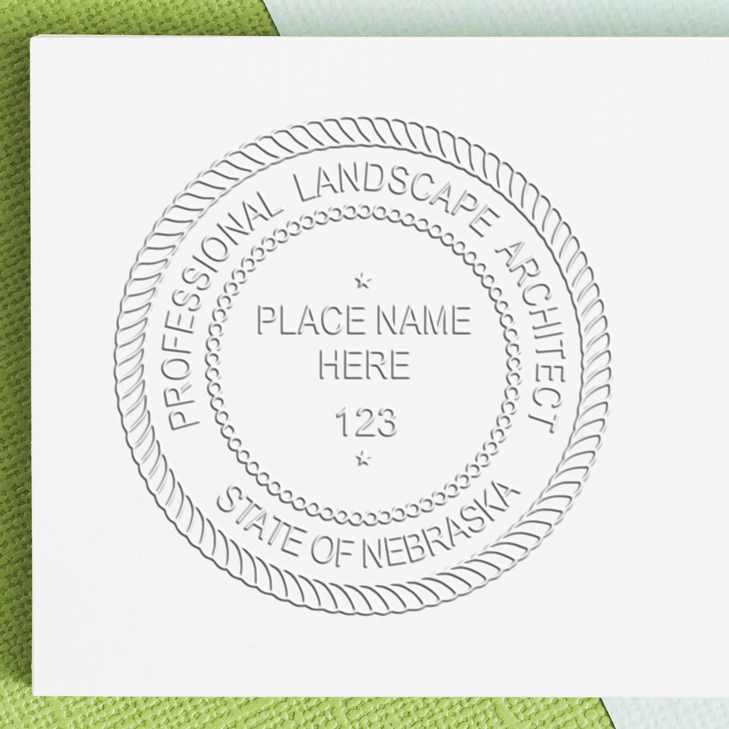 A stamped impression of the State of Nebraska Handheld Landscape Architect Seal in this stylish lifestyle photo, setting the tone for a unique and personalized product.