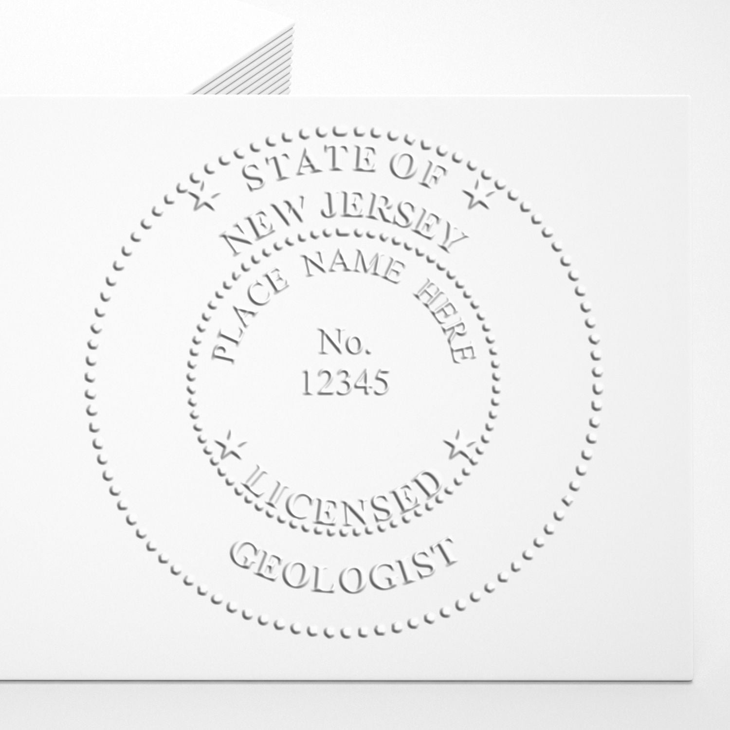 An in use photo of the New Jersey Geologist Desk Seal showing a sample imprint on a cardstock