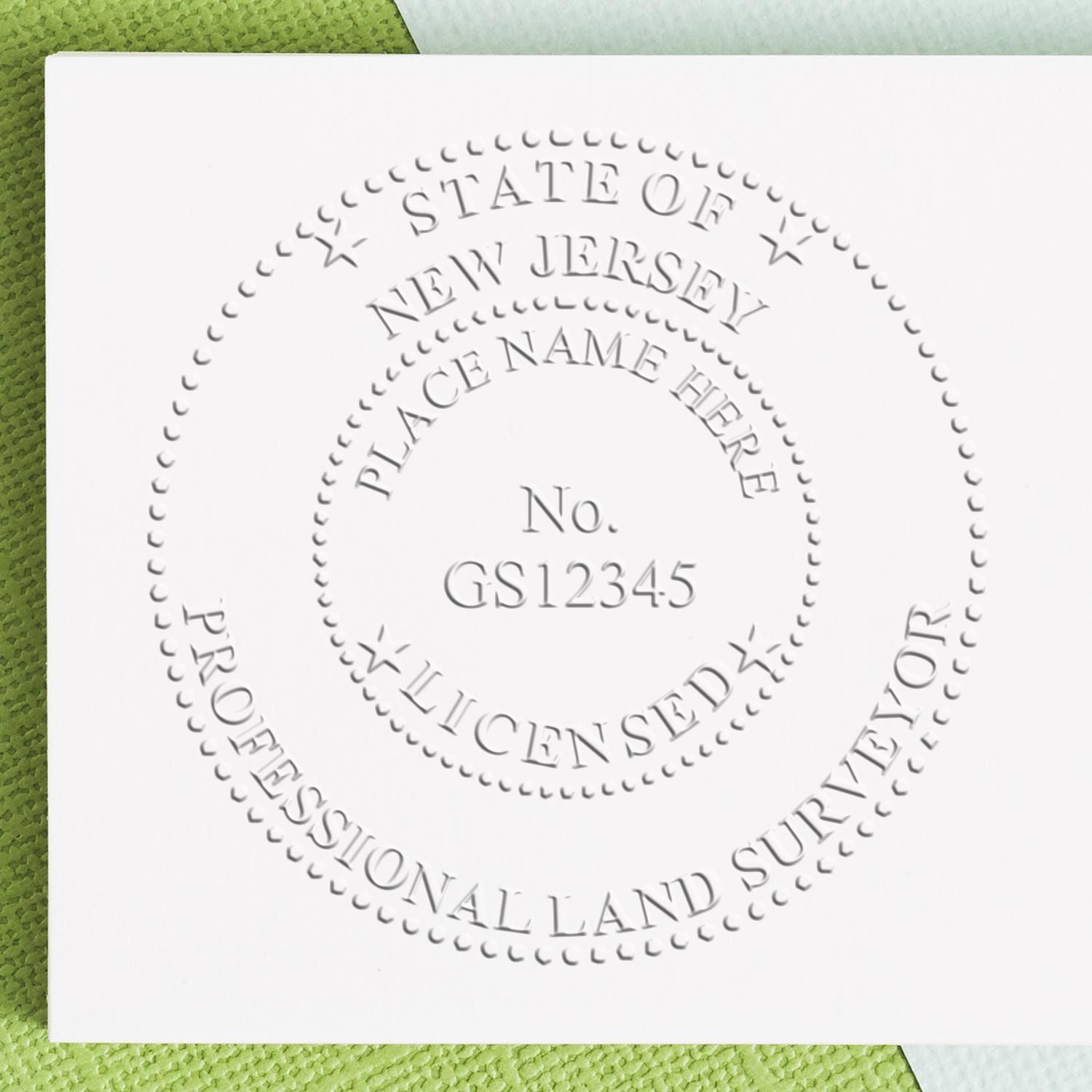 Another Example of a stamped impression of the Heavy Duty Cast Iron New Jersey Land Surveyor Seal Embosser on a piece of office paper.