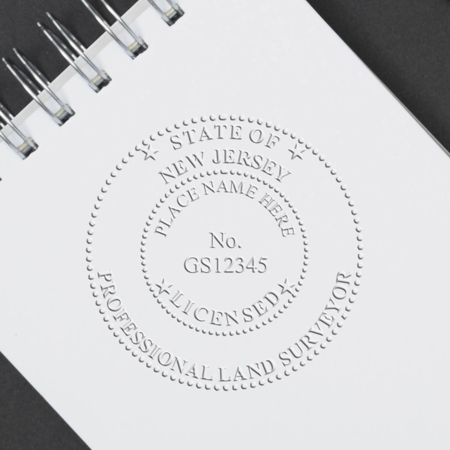 A stamped impression of the Handheld New Jersey Land Surveyor Seal in this stylish lifestyle photo, setting the tone for a unique and personalized product.