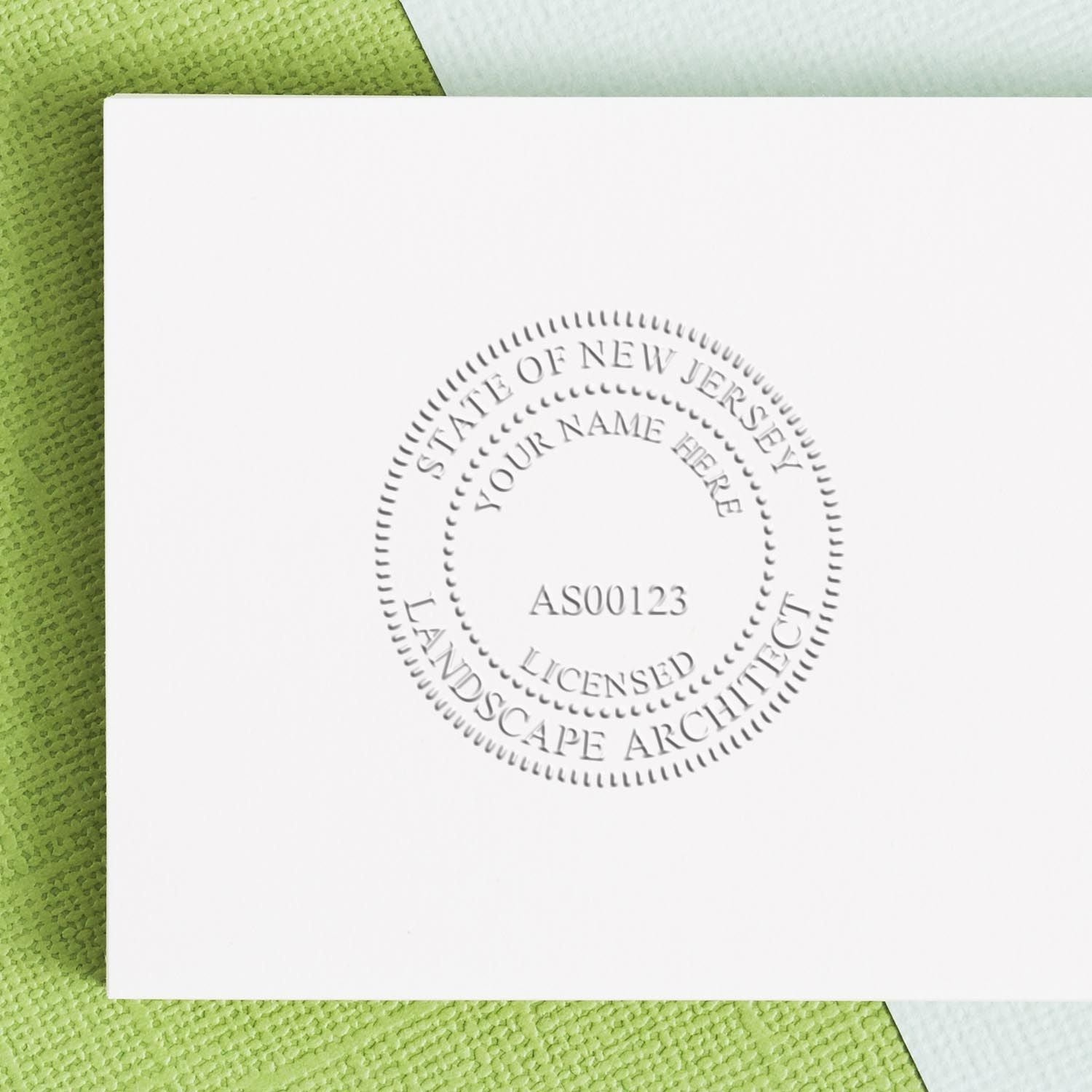 A lifestyle photo showing a stamped image of the State of New Jersey Extended Long Reach Landscape Architect Seal Embosser on a piece of paper