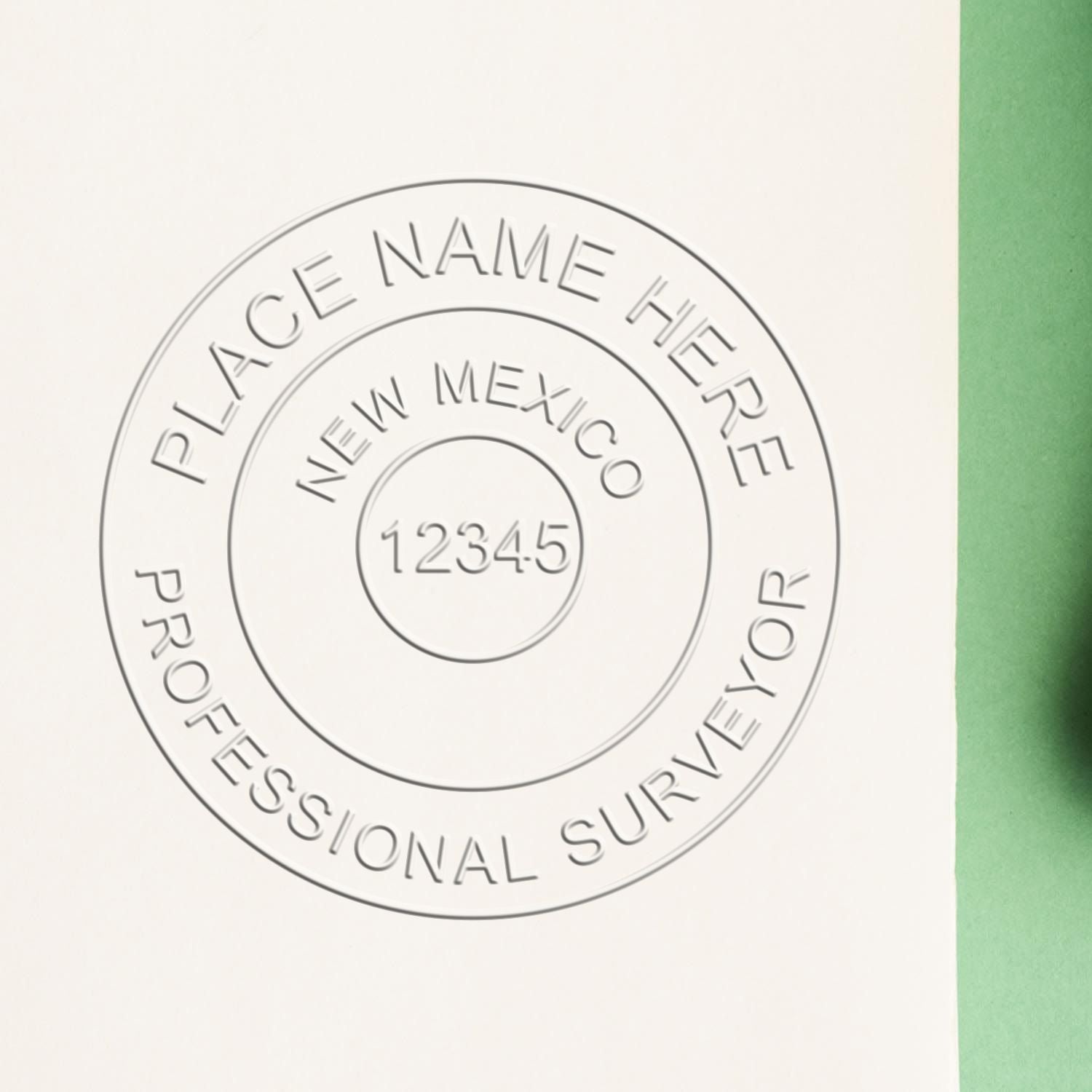 A lifestyle photo showing a stamped image of the Handheld New Mexico Land Surveyor Seal on a piece of paper