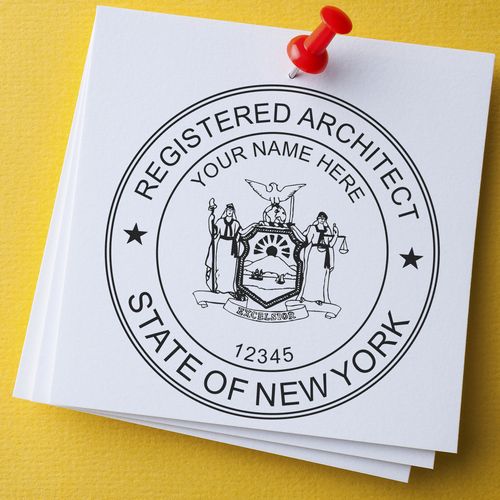 Premium MaxLight Pre-Inked New York Architectural Stamp on white paper with a red pushpin, displaying the New York State Registered Architect seal.