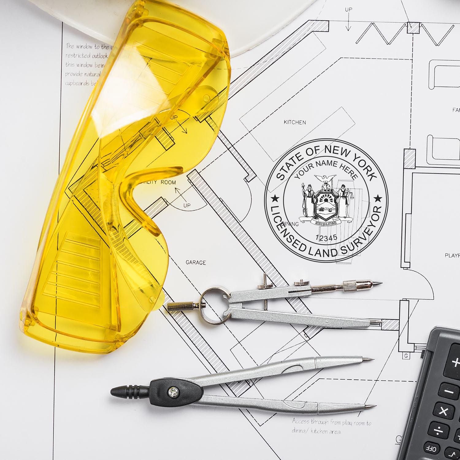 Yellow safety glasses, compass, and Self Inking New York Land Surveyor Stamp on architectural plans.