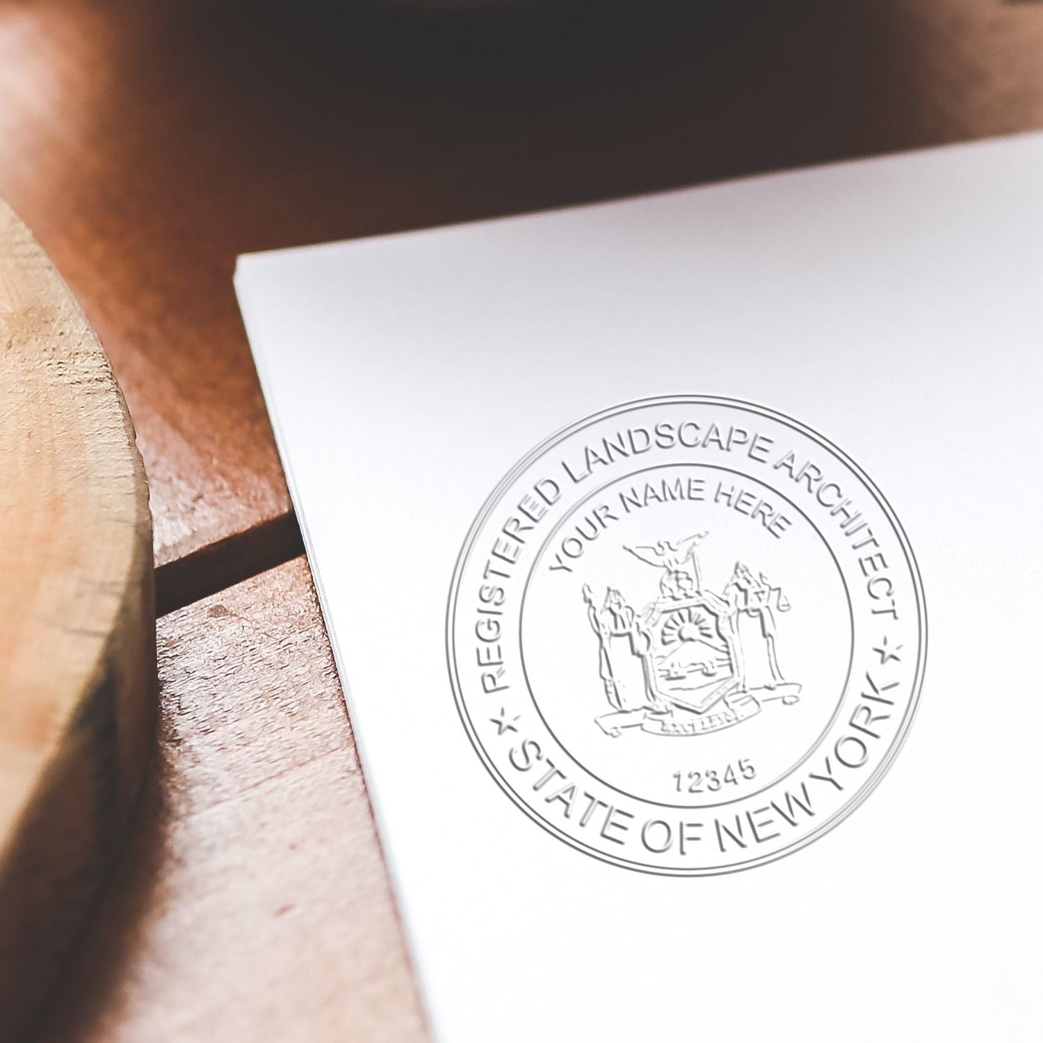 A photograph of the New York Desk Landscape Architectural Seal Embosser stamp impression reveals a vivid, professional image of the on paper.