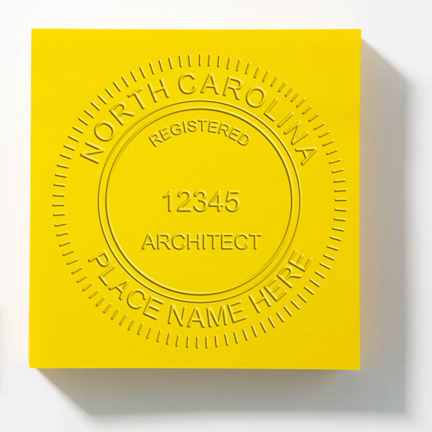 State of North Carolina Long Reach Architectural Embossing Seal in use photo showing a stamped imprint of the State of North Carolina Long Reach Architectural Embossing Seal